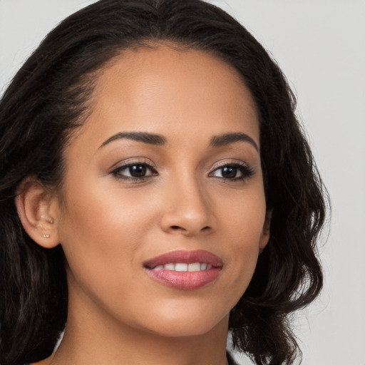 Joyful latino young-adult female with long  brown hair and brown eyes