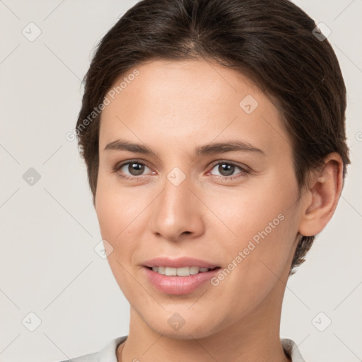 Joyful white young-adult female with short  brown hair and brown eyes