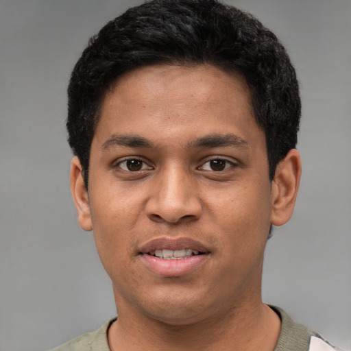 Joyful white young-adult male with short  black hair and brown eyes