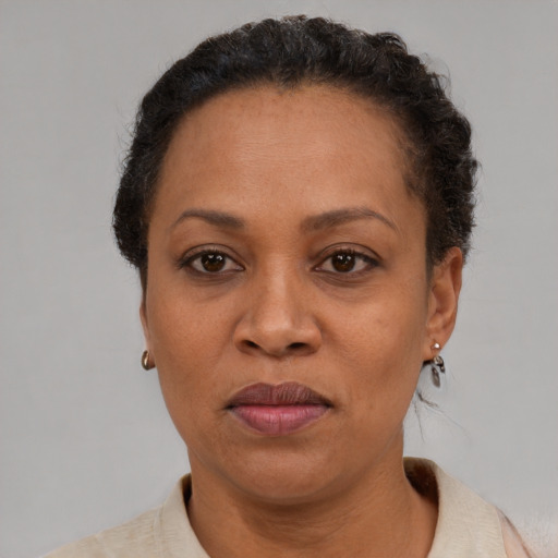 Joyful black adult female with short  brown hair and brown eyes