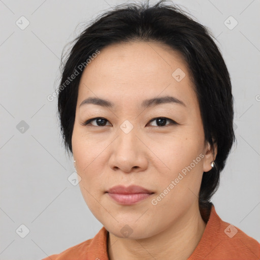 Joyful asian adult female with medium  black hair and brown eyes