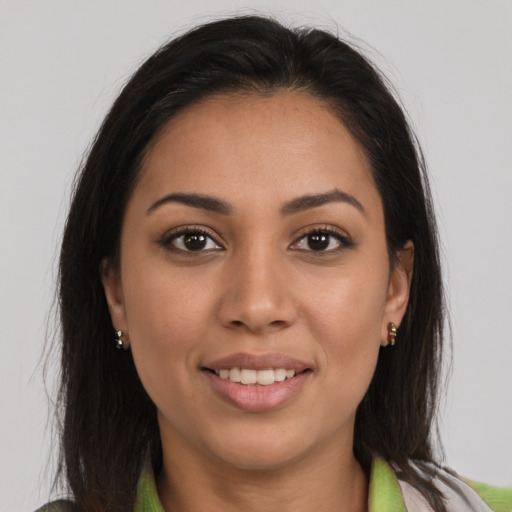 Joyful latino young-adult female with long  brown hair and brown eyes