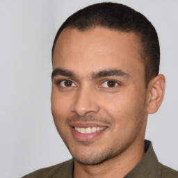 Joyful white young-adult male with short  black hair and brown eyes