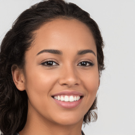 Joyful latino young-adult female with long  brown hair and brown eyes