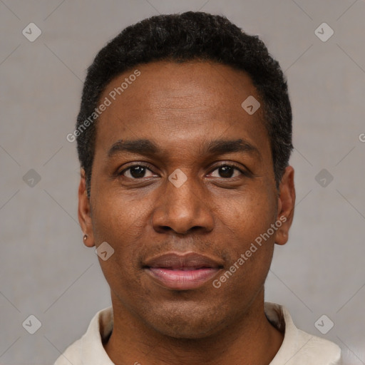 Joyful black young-adult male with short  black hair and brown eyes