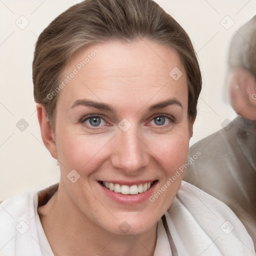 Joyful white young-adult female with medium  brown hair and grey eyes