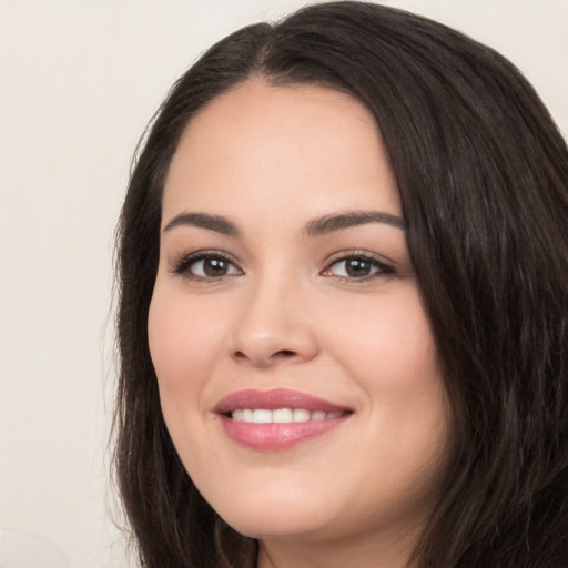 Joyful white young-adult female with long  black hair and brown eyes