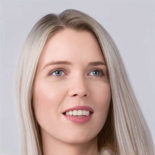 Joyful white young-adult female with long  brown hair and blue eyes