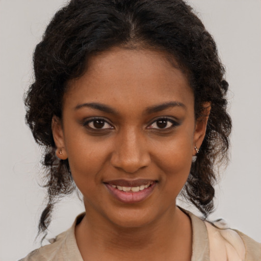 Joyful black young-adult female with medium  brown hair and brown eyes