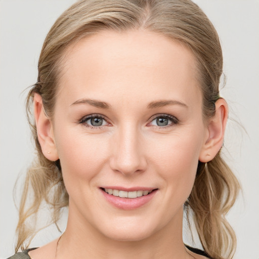 Joyful white young-adult female with medium  brown hair and blue eyes