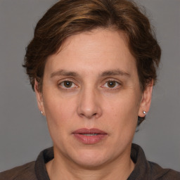 Joyful white adult female with medium  brown hair and grey eyes