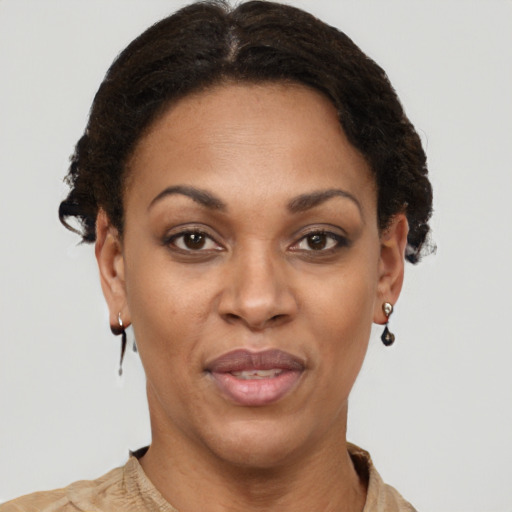 Joyful black adult female with short  brown hair and brown eyes