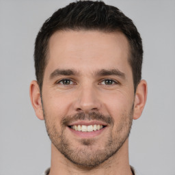 Joyful white young-adult male with short  brown hair and brown eyes