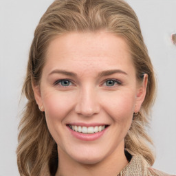 Joyful white young-adult female with medium  brown hair and blue eyes