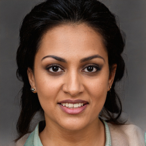 Joyful latino young-adult female with medium  brown hair and brown eyes