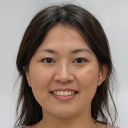 Joyful white young-adult female with medium  brown hair and brown eyes