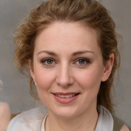 Joyful white adult female with medium  brown hair and grey eyes