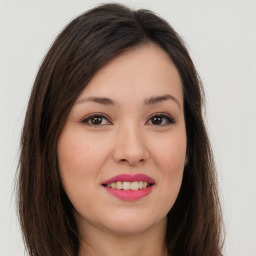 Joyful asian young-adult female with long  brown hair and brown eyes