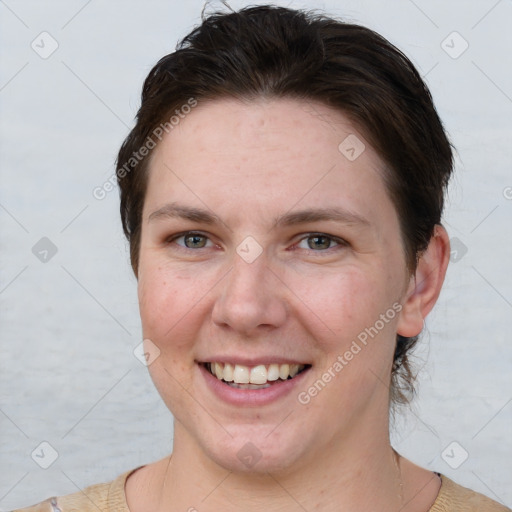 Joyful white adult female with short  brown hair and grey eyes