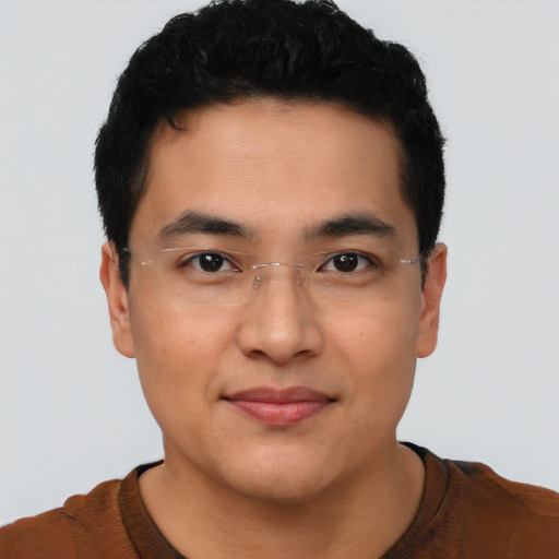 Joyful asian young-adult male with short  black hair and brown eyes