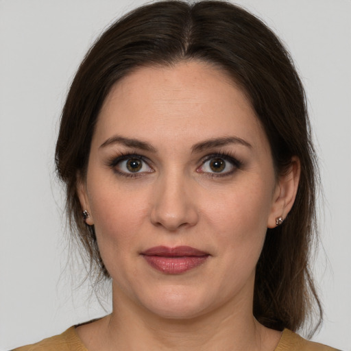 Joyful white young-adult female with medium  brown hair and brown eyes