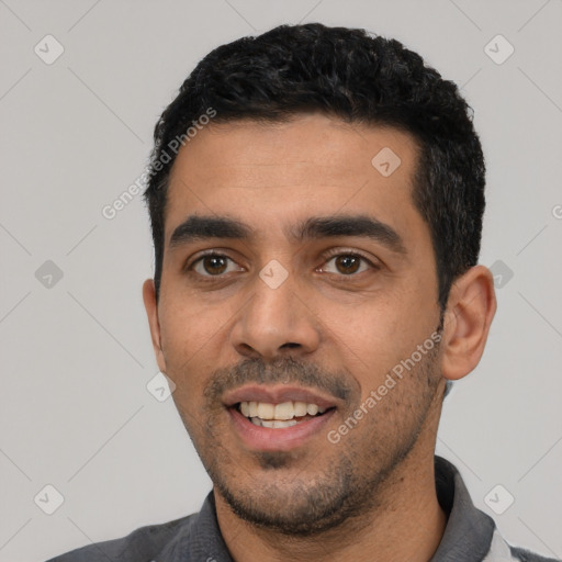 Joyful white young-adult male with short  black hair and brown eyes