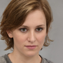 Joyful white young-adult female with medium  brown hair and blue eyes