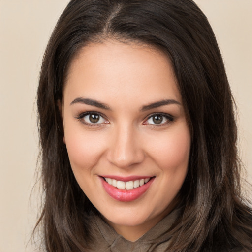 Joyful white young-adult female with long  brown hair and brown eyes