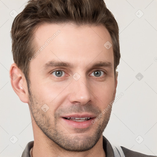 Joyful white young-adult male with short  brown hair and grey eyes