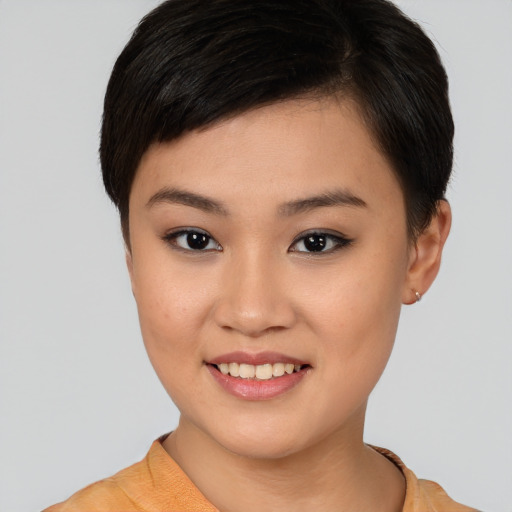 Joyful asian young-adult female with short  brown hair and brown eyes