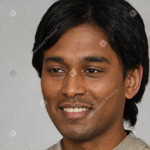 Joyful black young-adult male with short  black hair and brown eyes