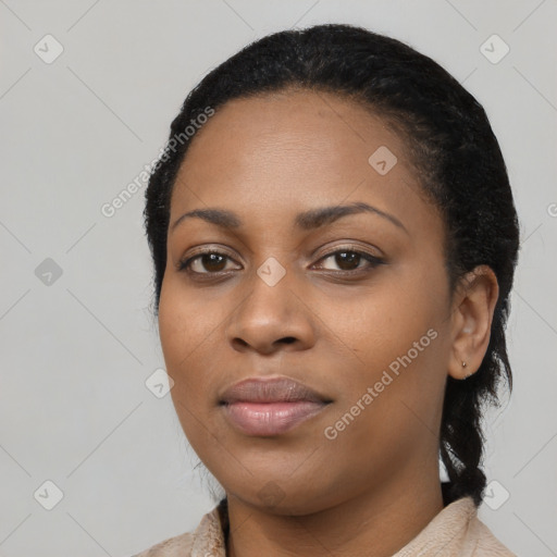 Joyful black young-adult female with long  black hair and brown eyes