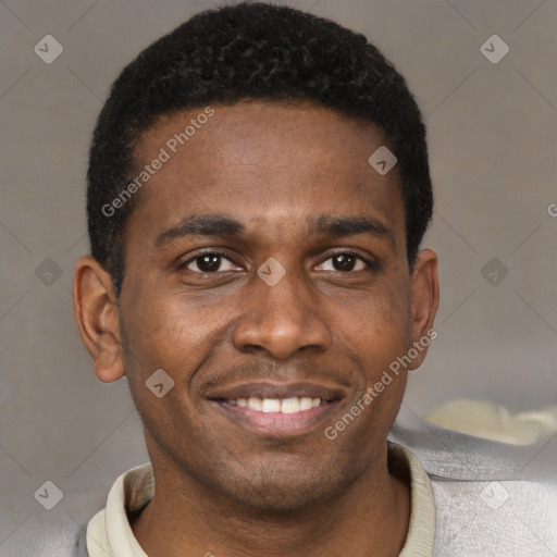 Joyful black young-adult male with short  brown hair and brown eyes