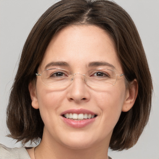 Joyful white adult female with medium  brown hair and grey eyes