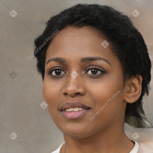 Joyful black young-adult female with short  black hair and brown eyes