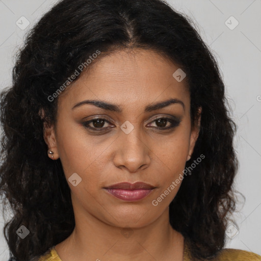 Joyful black young-adult female with long  brown hair and brown eyes