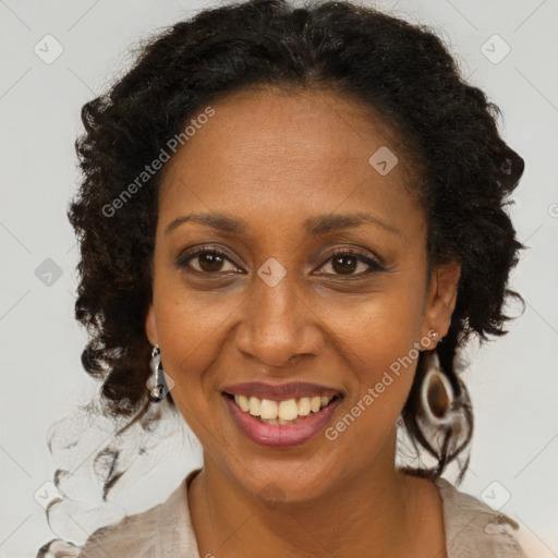 Joyful black adult female with long  brown hair and brown eyes