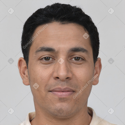 Joyful latino young-adult male with short  black hair and brown eyes