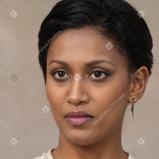 Joyful black young-adult female with short  brown hair and brown eyes