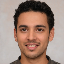 Joyful white young-adult male with short  black hair and brown eyes