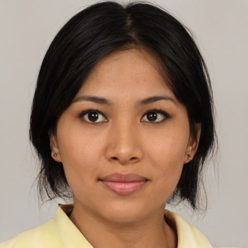 Joyful asian young-adult female with medium  brown hair and brown eyes