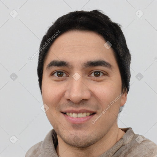 Joyful white young-adult male with short  black hair and brown eyes