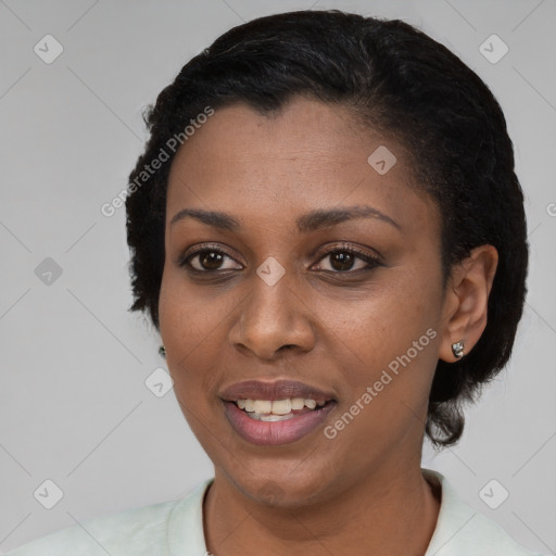 Joyful black young-adult female with short  black hair and brown eyes