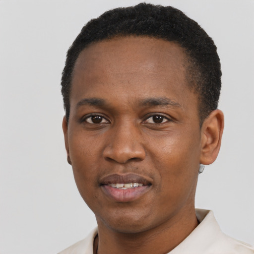 Joyful black young-adult male with short  black hair and brown eyes