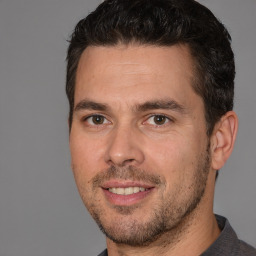 Joyful white adult male with short  brown hair and brown eyes