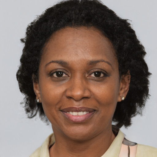 Joyful latino adult female with short  brown hair and brown eyes