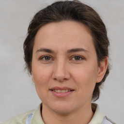 Joyful white adult female with medium  brown hair and brown eyes