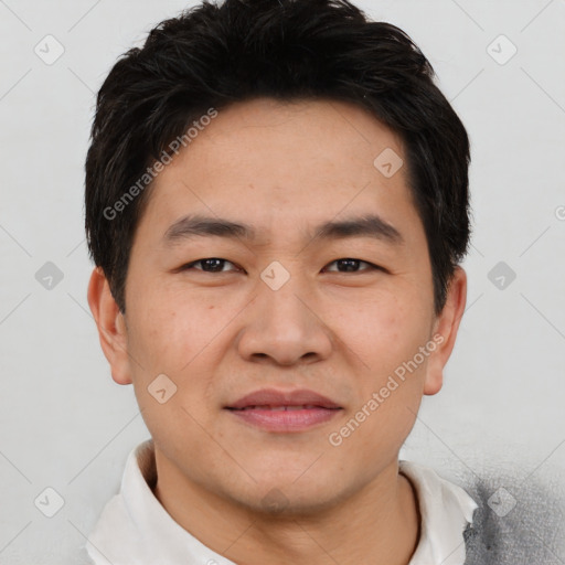 Joyful asian young-adult male with short  black hair and brown eyes