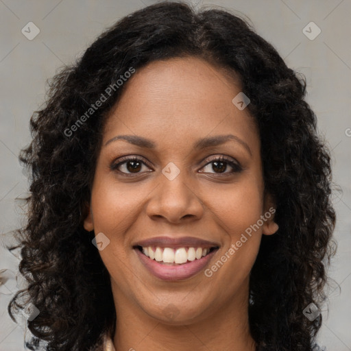 Joyful black young-adult female with long  brown hair and brown eyes