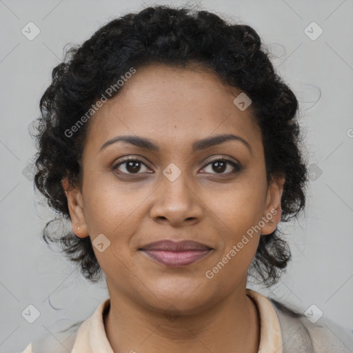 Joyful black young-adult female with long  brown hair and brown eyes